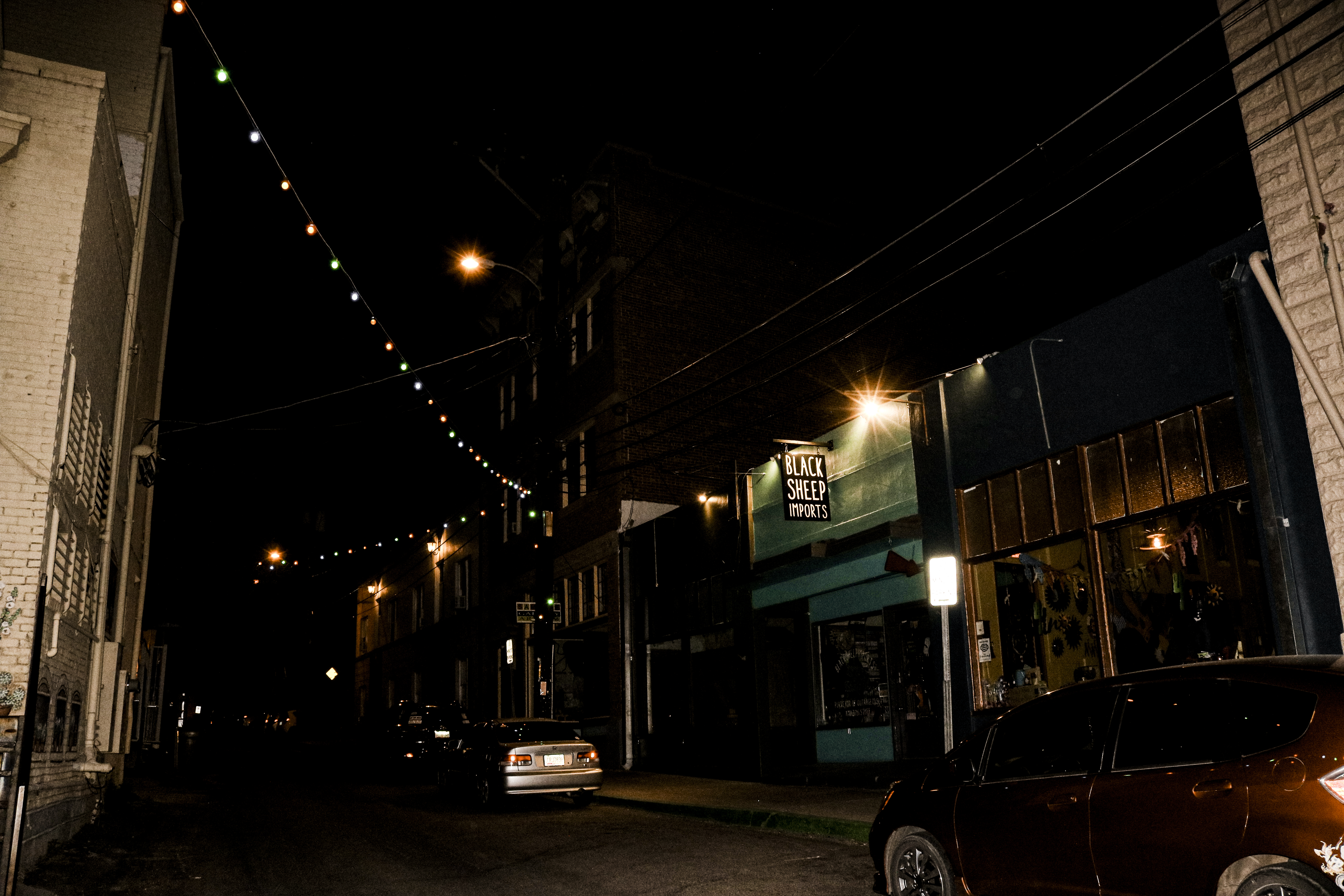 Shops on a street in downtown Old Bisbee at night.